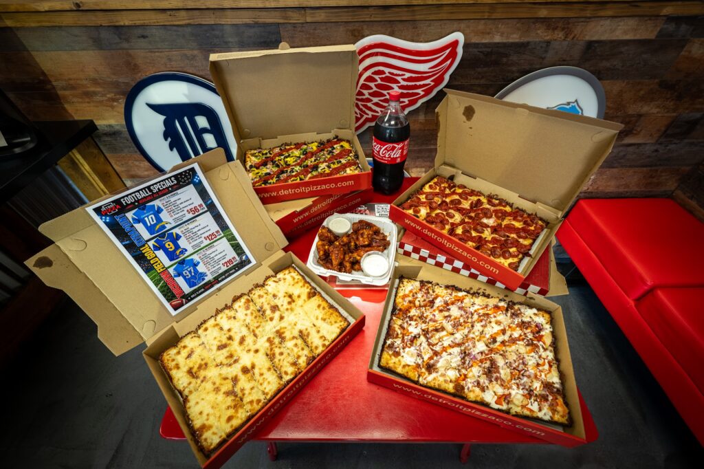 Game day pizza party spread of Detroit-style pizzas from Detroit Pizza Co.