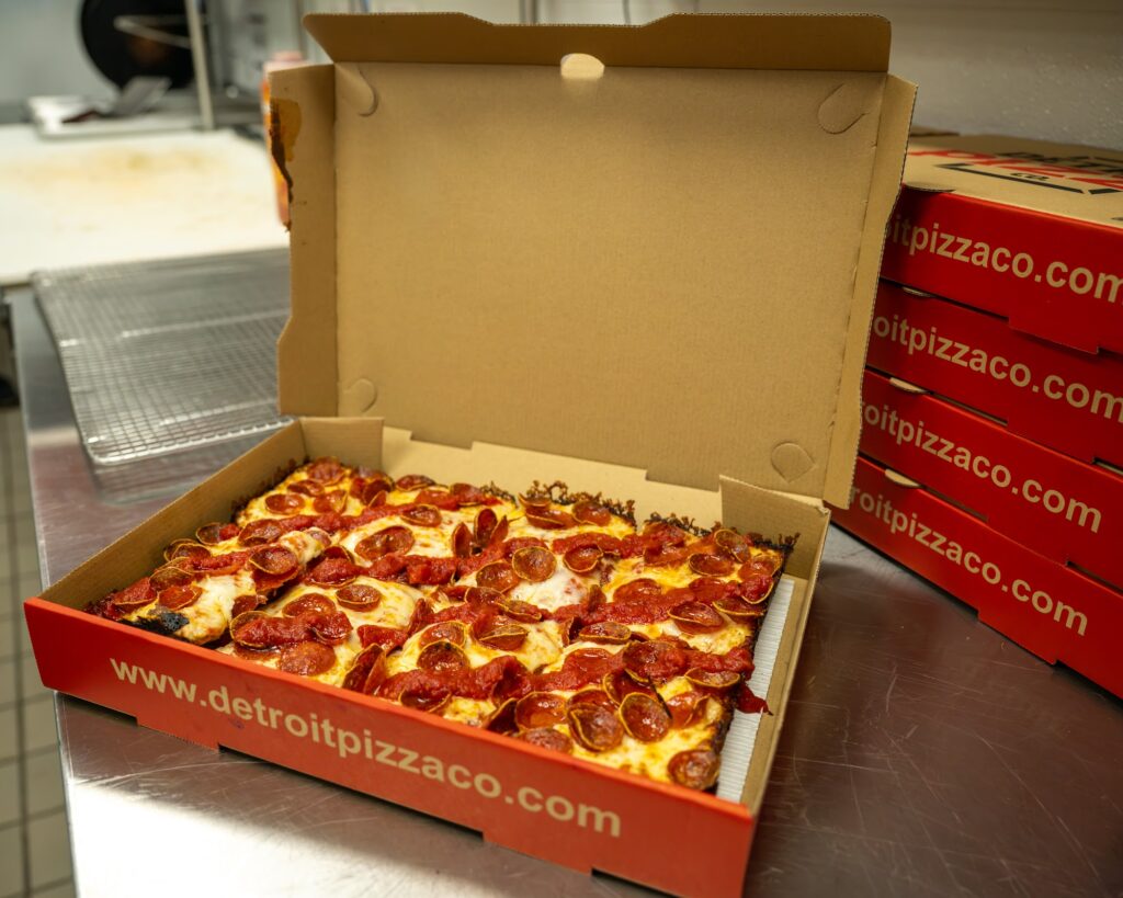 Fresh Detroit-style pepperoni pizza in an open box at Detroit Pizza Co.