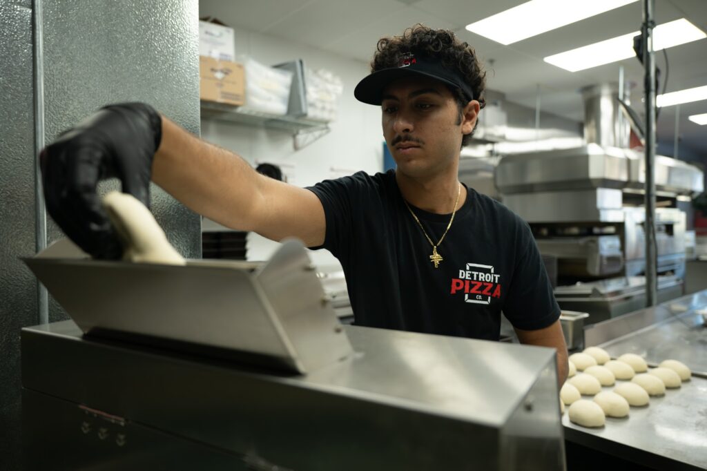 Detroit Pizza Co. team member making fresh dough in Murrieta