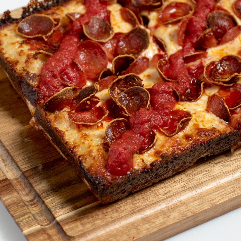 Double cupping pepperoni Detroit-style pizza with crispy cheese crust