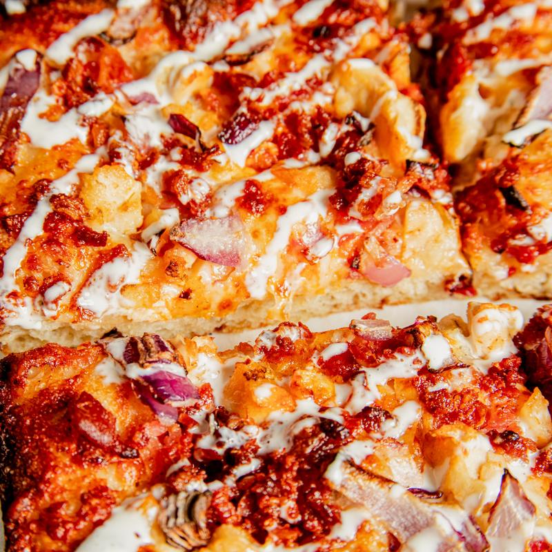 Detroit Buffalo Blaze pizza close-up with chicken, bacon, red onion and ranch
