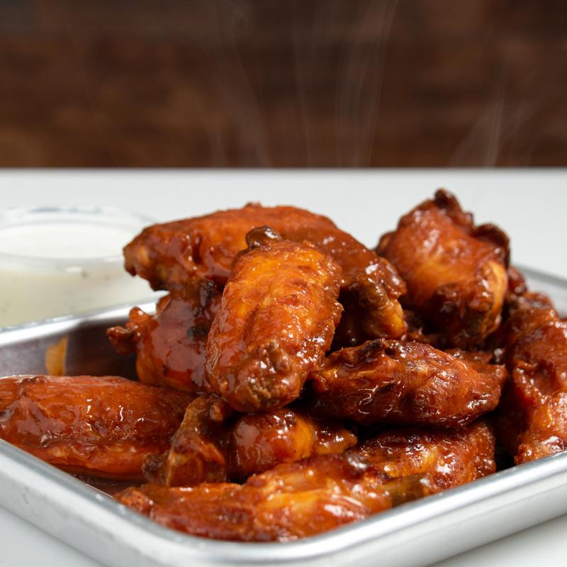 DPC chicken wings tossed in sauce with ranch